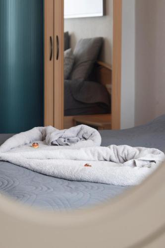 a white blanket sitting on top of a bed at Casa Lauda in Bad Vöslau in Bad Vöslau