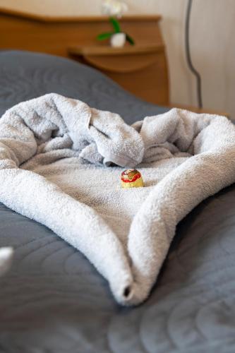 a white blanket on a bed with a strawberry on it at Casa Lauda in Bad Vöslau in Bad Vöslau