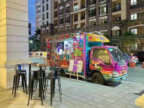 a colorful food truck parked next to a street at NAIA Terminal 3 Condo Newport with WIFI Netflix Pool in Manila