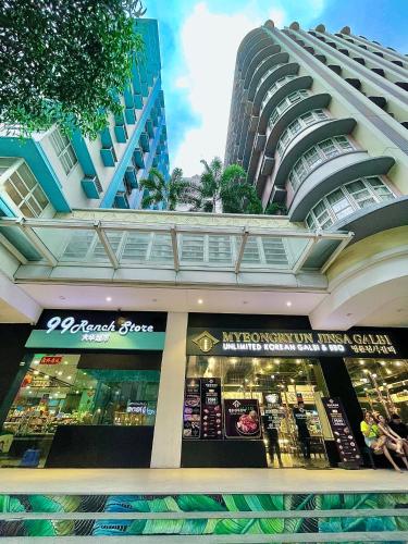 a store in front of a tall building at NAIA Terminal 3 Condo Newport with WIFI Netflix Pool in Manila