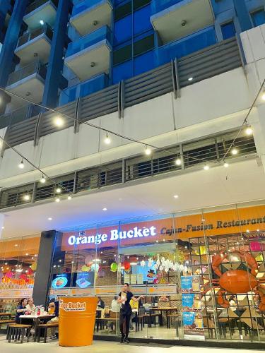 an orange bucket restaurant in a building with people in it at NAIA Terminal 3 Condo Newport with WIFI Netflix Pool in Manila