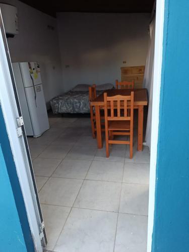 a room with a table and chairs and a bedroom at departamento mar de ostende in Ostende