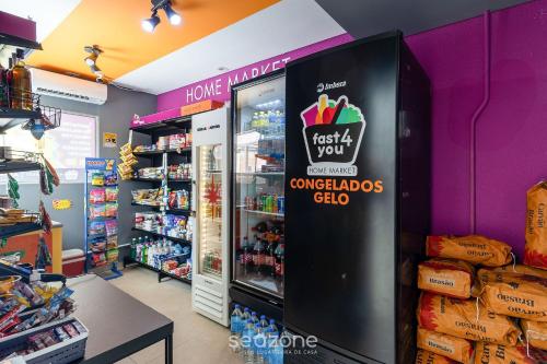 a store with a refrigerator with a sign that reads just let you get yourselves chi at Apto Moderno c/ piscina prox. da Praia AVR0203 in Piçarras