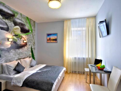 a bedroom with a bed and a table and a desk at Golden Gate Inn in Kyiv