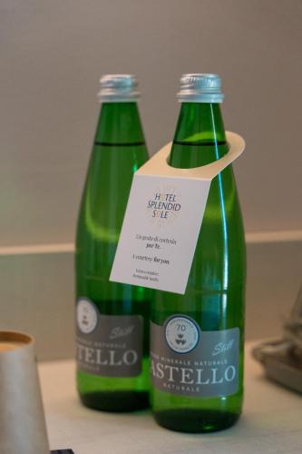 two bottles of soda sitting on top of a table at Spa Hotel Splendid Sole in Manerba del Garda