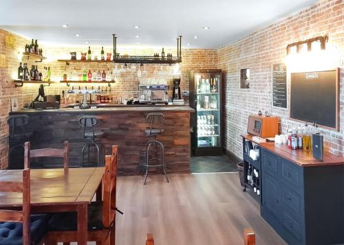 a kitchen with a bar with a table and chairs at Springhouse Country Park in Slaley