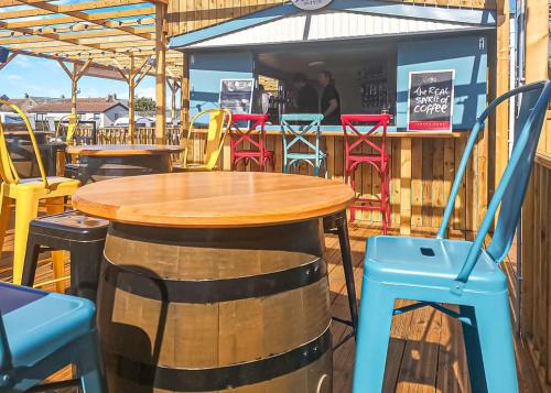 a wooden table and chairs on a patio at Stanwix Park in Silloth