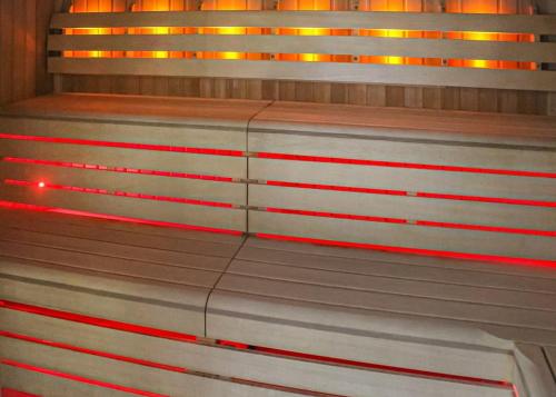 a bench with red lights on top of it at Stanwix Park in Silloth