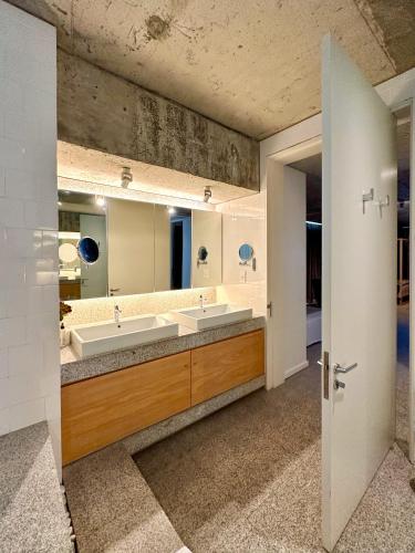 a bathroom with two sinks and a large mirror at Silver Bay Villa in Stompneusbaai