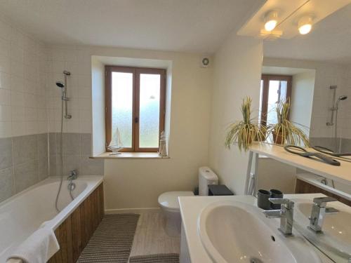 une salle de bain avec une baignoire, un lavabo et des toilettes dans l'établissement Gîte vert à Saint-Méard-de-Drône avec terrasse et piscine partagée - FR-1-616-469, à Villetoureix