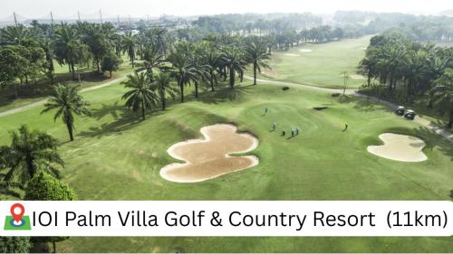 a view of a golf course with palm villa golf country resort at YK Homestay in Kulai