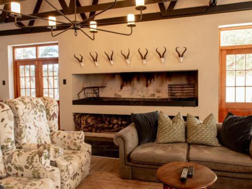 a living room with a couch and a fireplace at Kareestomp in Aberdeen