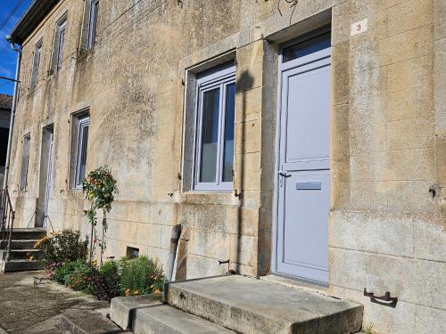 a white door on the side of a building at Gîte historique et moderne, capacité flexible - FR-1-585-170 in Mouzay