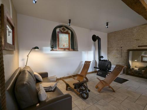 a living room with a couch and chairs and a fireplace at Gîte historique et moderne, capacité flexible - FR-1-585-170 in Mouzay