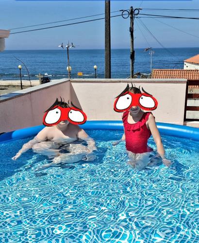 two people in a swimming pool in the water at Casa de Mi mar in Viana do Castelo