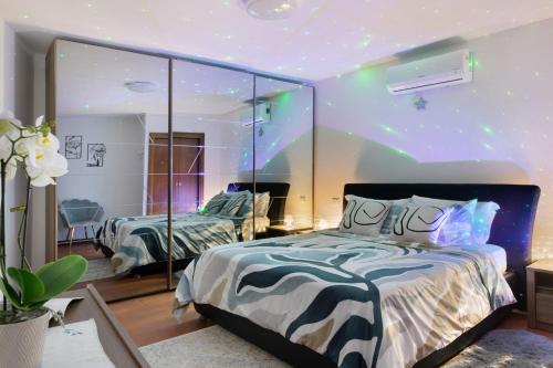 a bedroom with two beds and a large mirror at Dina’s Flower House in Lierna