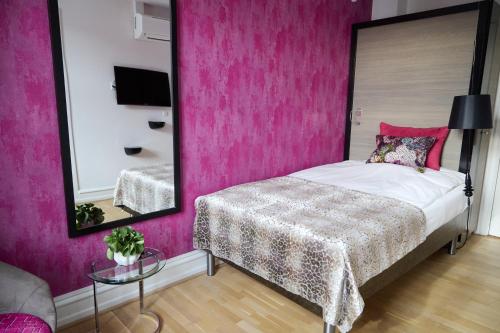 Postel nebo postele na pokoji v ubytování Andersen Boutique Hotel