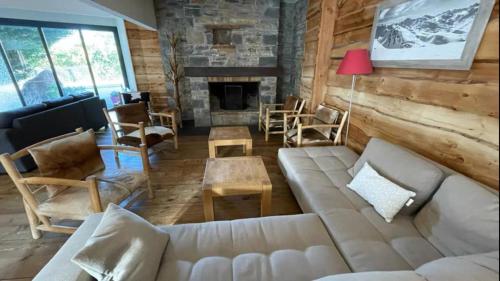 a living room with a couch and a fireplace at Nid cosy avec vue montagne au coeur de saint lary in Saint-Lary-Soulan