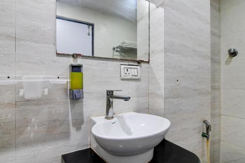 a bathroom with a sink and a mirror at FabHotel Prime Eco Park - New Town in New Town