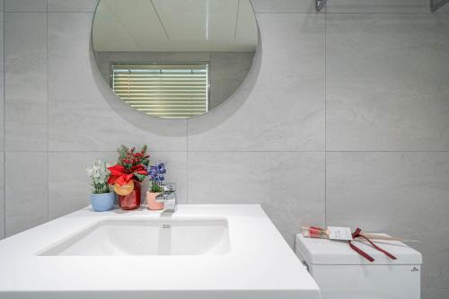 a bathroom with a white tub and a mirror at Gwanganri HOTEL OCEANVIEW in Busan