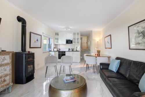 a living room with a couch and a table at Celestial Blue Vale Do Lobo in Almancil