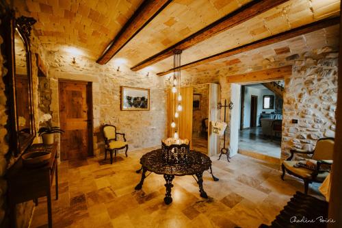 a living room with a table in the middle at Domaine de coulette in Vallon-Pont-dʼArc