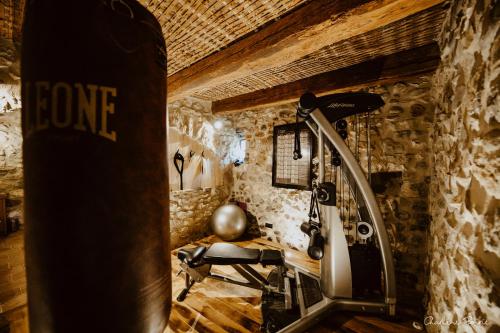 a gym with a bike in a room at Domaine de coulette in Vallon-Pont-dʼArc
