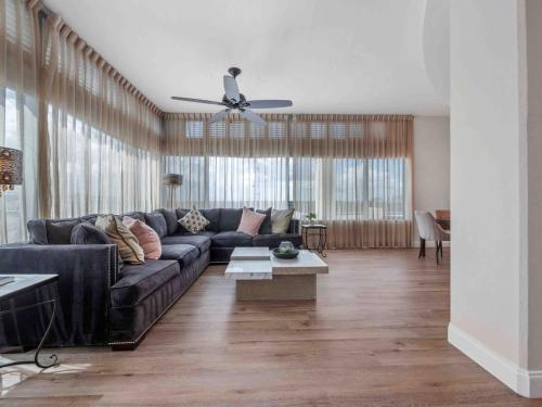 a living room with a couch and a ceiling fan at PentHouse Downtown Orlando 2 Beds 2 baths in Orlando