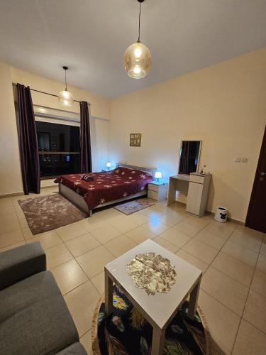 a large living room with a bed and a table at Master bedroom in JBR in Dubai