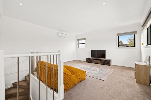 a white room with a bed and a fireplace at Domi Rentals - The Fregon Townhouse in Clayton North