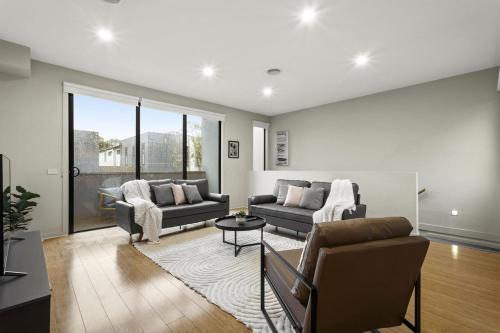 a living room with a couch and a table at The Brighton Townhouse in Melbourne