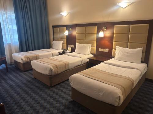 a hotel room with two beds in a room at Orchid Hotel Deira in Dubai