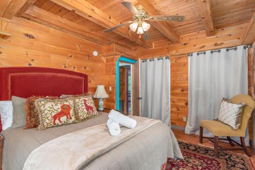 a bedroom with a bed and a ceiling fan at Secluded Cabin with Quality Furnishing and Hot Tub in Leicester