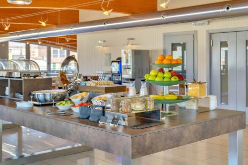 a buffet line with fruits and other food on display at B&B HOTEL Milano La Spezia in Milan