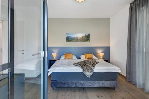 a bedroom with a bed and a glass wall at New Opening Vinea Guesthouse in Cornedo all'Isarco