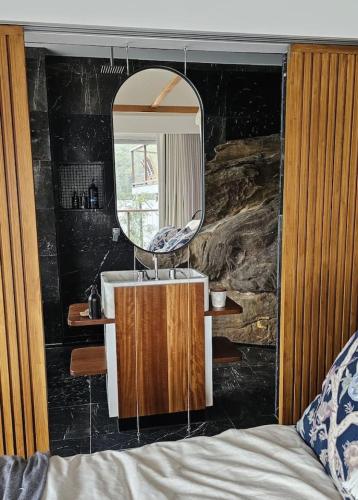 a bathroom with a sink and a mirror at Pagoda Point in Bar Point