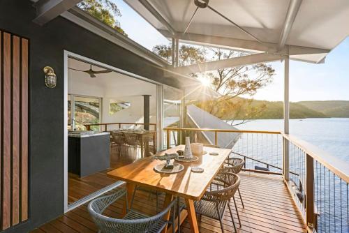 a wooden deck with a table and chairs on a boat at Pagoda Point in Bar Point