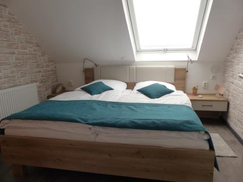 a bedroom with a large bed with a window at Ferienwohnung Regia Fulda - Künzell - Bachrain in Fulda