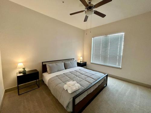 a bedroom with a bed and a ceiling fan at Central Heights functional 2B2B Longterm Condo in Houston