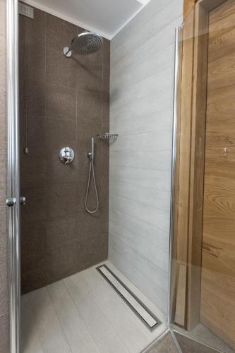 a shower with a glass door in a bathroom at Sottovento Luxury Hospitality in Bormio