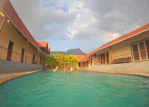 a group of people in the water in a swimming pool at Break the Routine, Malshej in Murbād