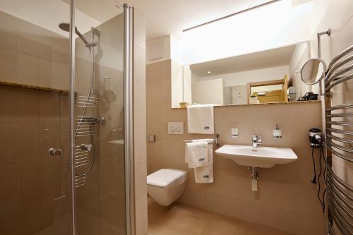 a bathroom with a toilet and a sink and a shower at Pension Ježník in Krnov