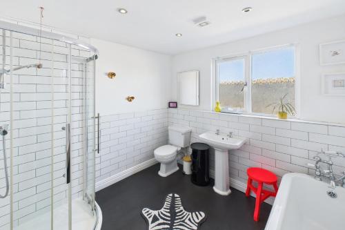 a white bathroom with a sink and a toilet at Host & Stay - The Artists Pad in Saltburn-by-the-Sea