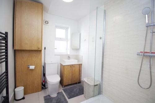 a bathroom with a toilet and a sink and a shower at Lovely 1-Bedroom Flat in London near Blackhorse Rd in London