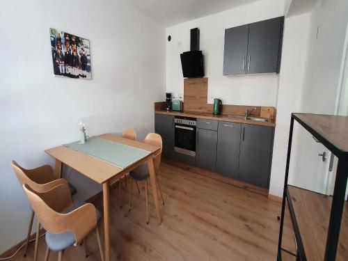 a kitchen with a table and chairs in a room at Zeihäänger Stubb in Schwalmstadt