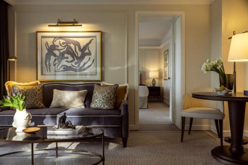 a living room with a couch and a table at Corinthia Palace Malta in Attard