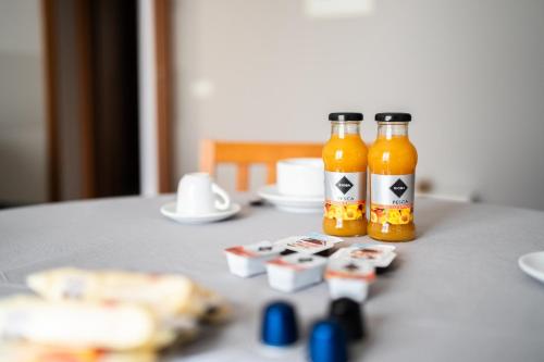 two bottles of beer sitting on top of a table at Residence Due Spade - Free Parking in Melzo
