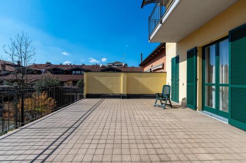 a chair sitting on a patio outside of a building at Residence Due Spade - Free Parking in Melzo