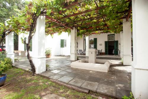 an outdoor patio with a pergola and a courtyard at Sundays Karoo Guesthouse in Graaff-Reinet