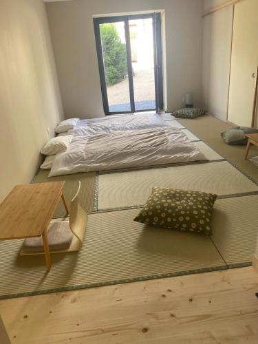 Postel nebo postele na pokoji v ubytování Maison Shizen